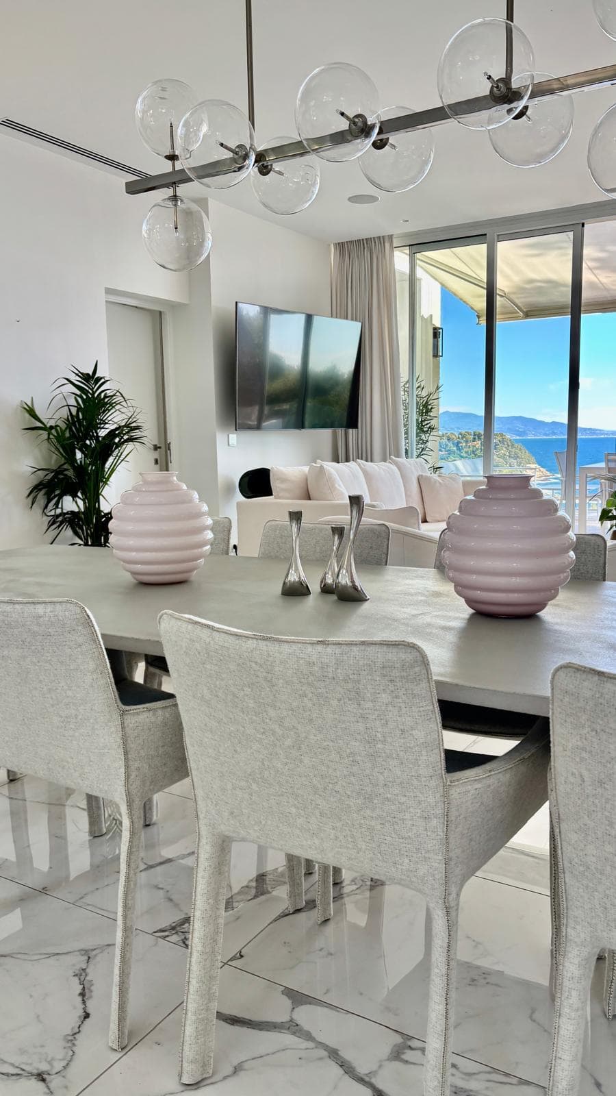 Villa Alcyone dining room styled with sculptural pink glassware